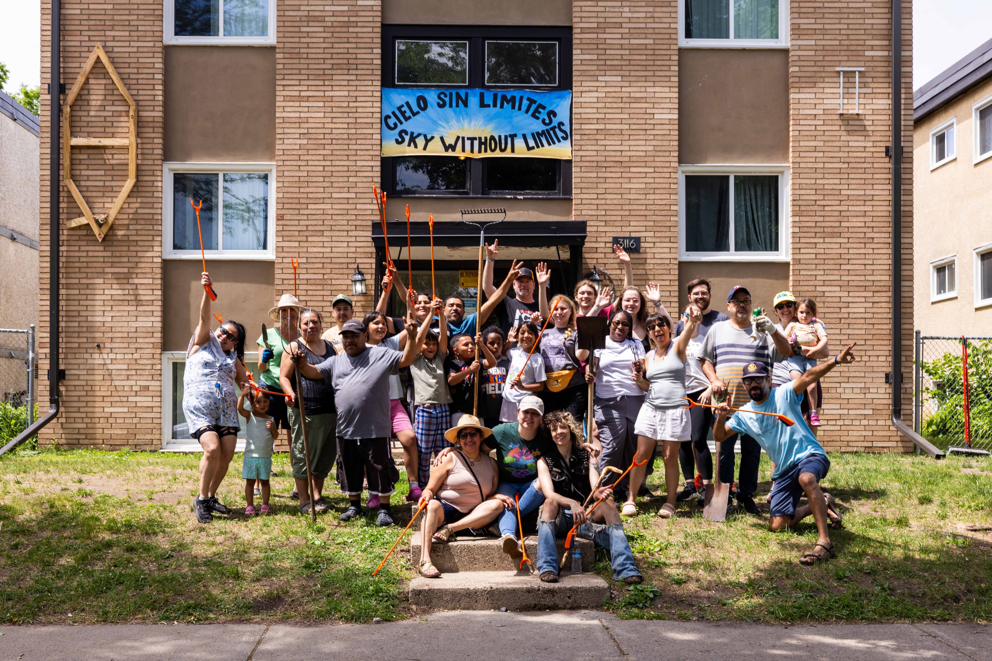 Members of the Sky Without Limits and community allies pose during a day working on the cooperative’s shared gardens.